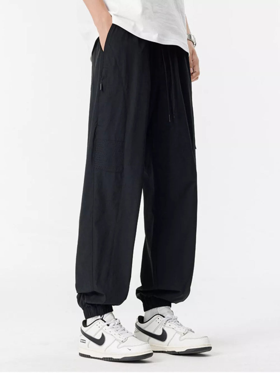 Black jogger sweatpants with drawstring and textured detail on the leg.