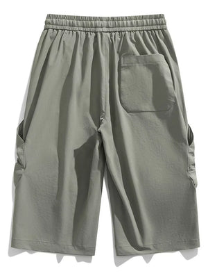 Light gray cargo capris with elastic waistband and drawstring, featuring side pockets and a back pocket.