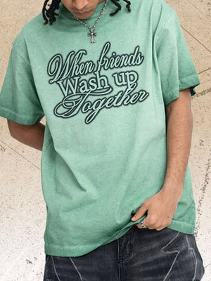 Men's green vintage wash graphic tee with crew neck and "When friends Wash up Together" text.