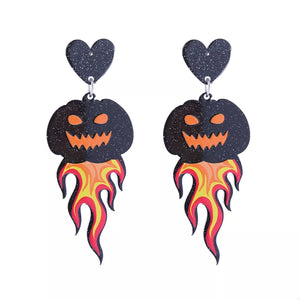Spooky dangle earrings with black glitter hearts and jack-o-lanterns on flames