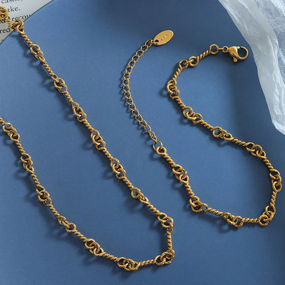 Gold twisted chain link bracelet with lobster clasp and adjustable chain.