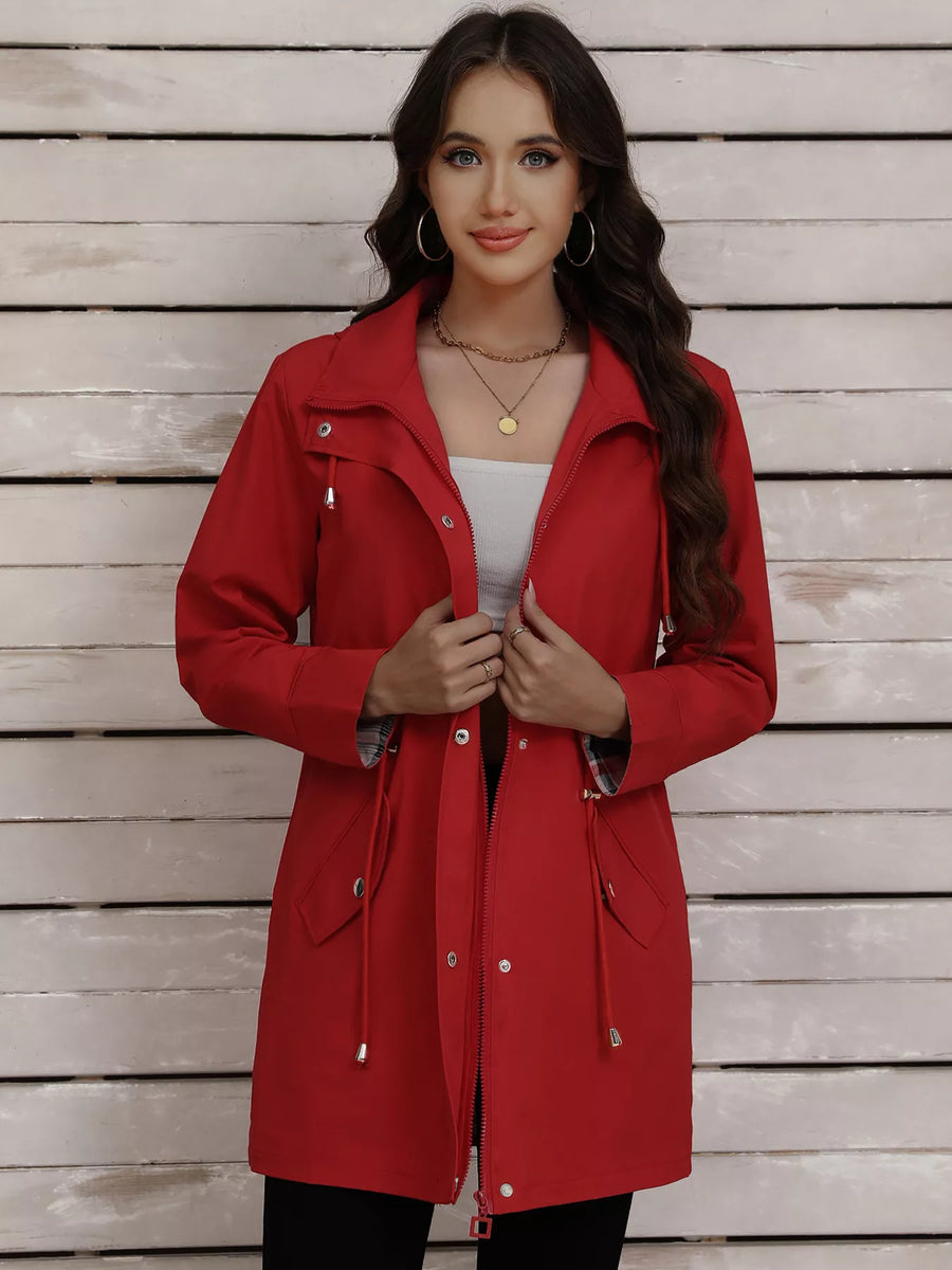 Red drawstring snap-down trench coat with zippered pockets and plaid lining.