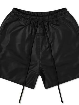 Black nylon drawstring shorts with curved hem detail and elastic waistband.