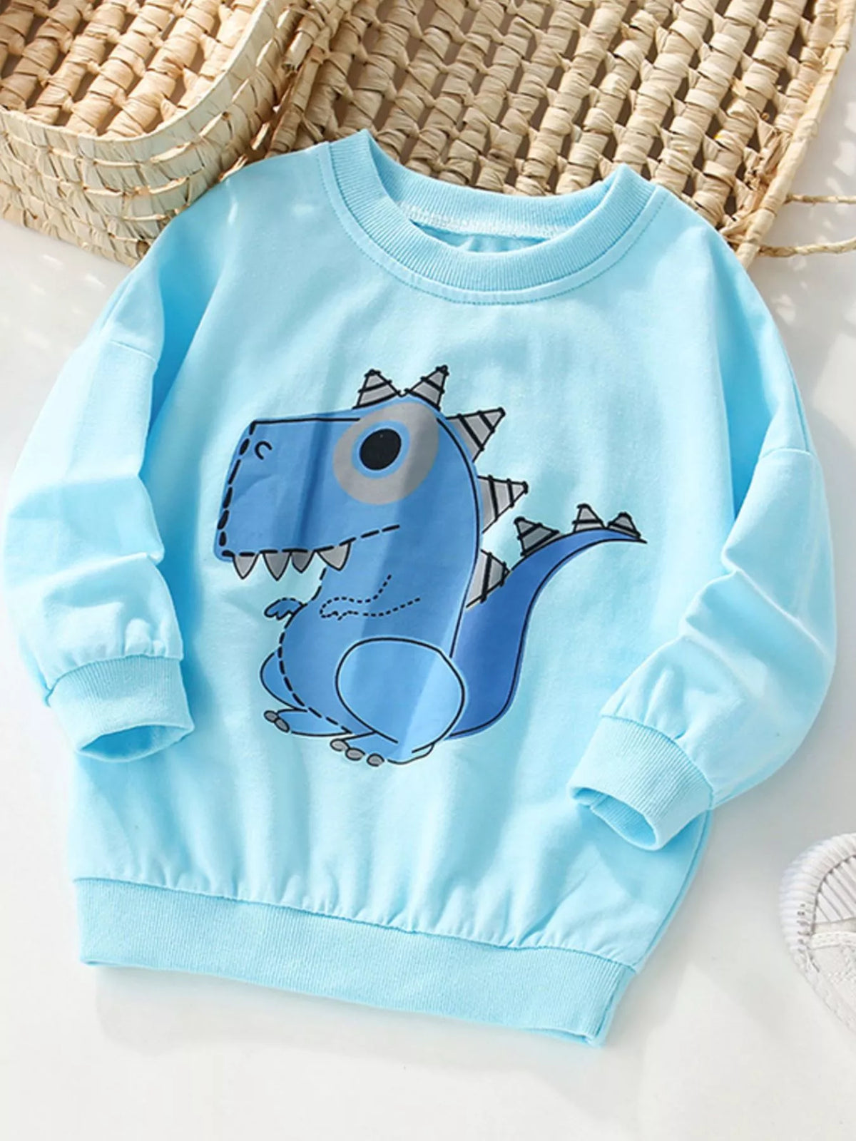 Baby blue crew neck sweatshirt with a cute blue dinosaur graphic.