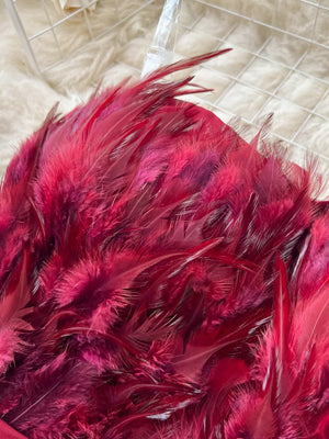 Wine red strapless jumpsuit with feather trim detail