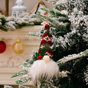 Knitted gnome ornament with red, green, and white striped hat, white beard, and holly detail.