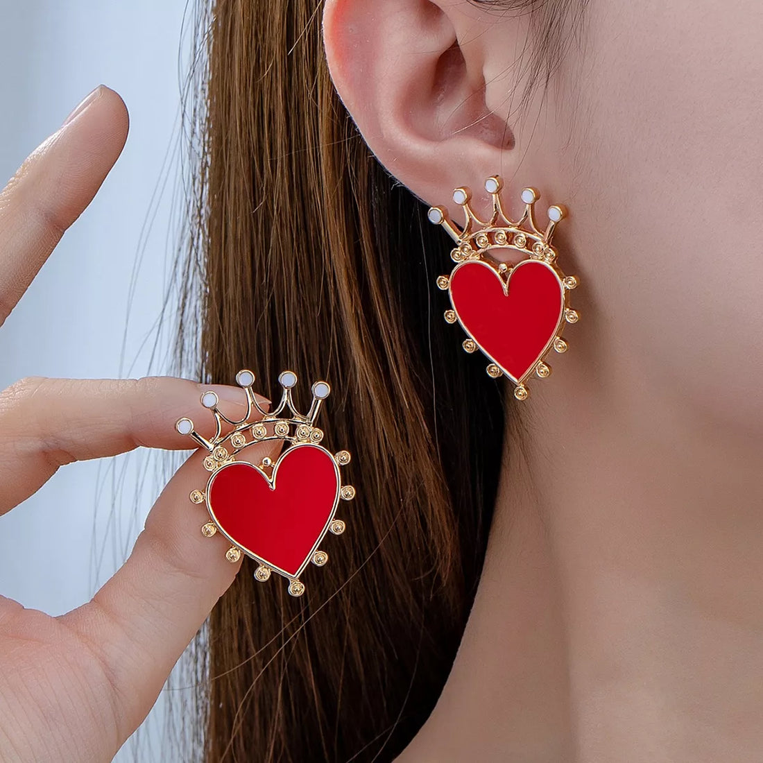 Red heart crown stud earrings with gold trim and white accents.