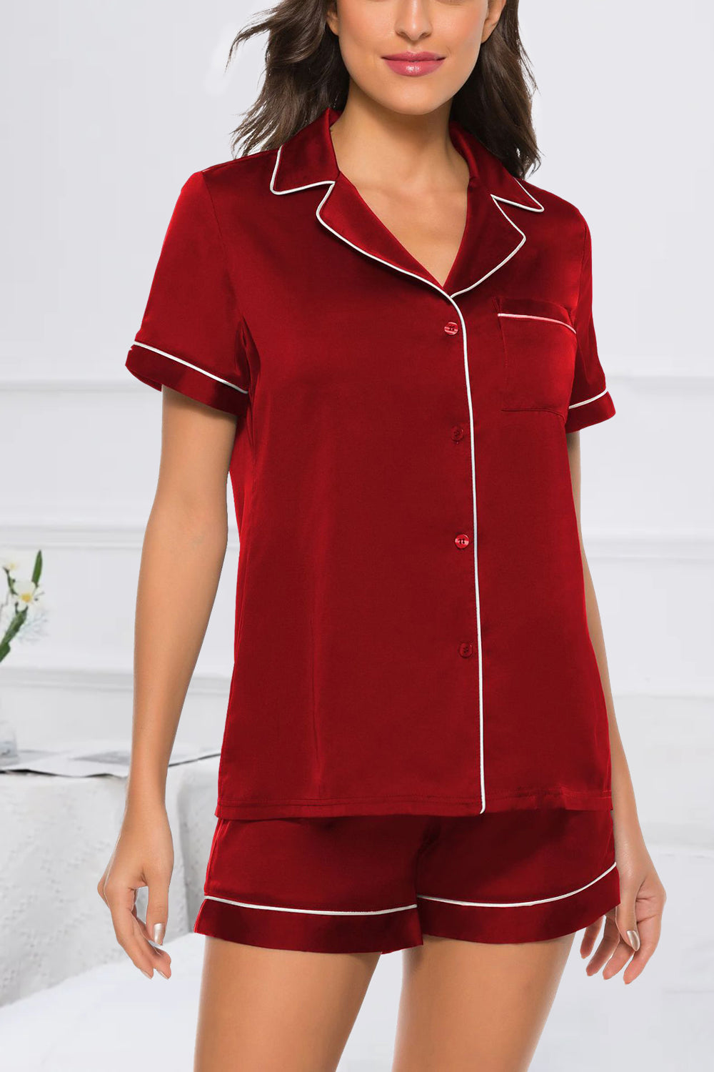 Scarlet satin pajama set with white piping, button front top and shorts.
