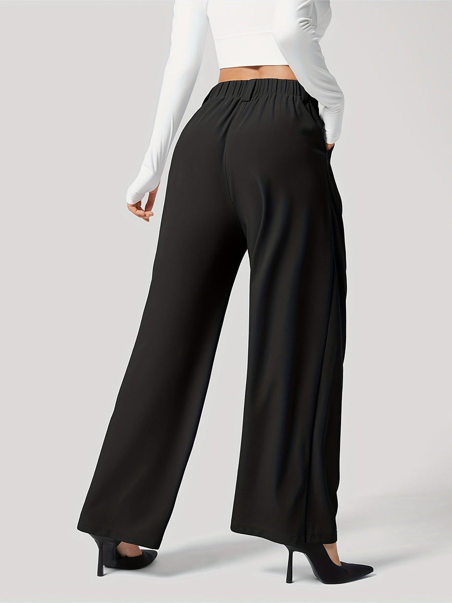Black pleated wide-leg tailored trousers with a relaxed fit and elastic waistband.