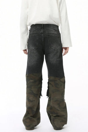Distressed wide-leg jeans with dark denim and camouflage panels, featuring raw hems.