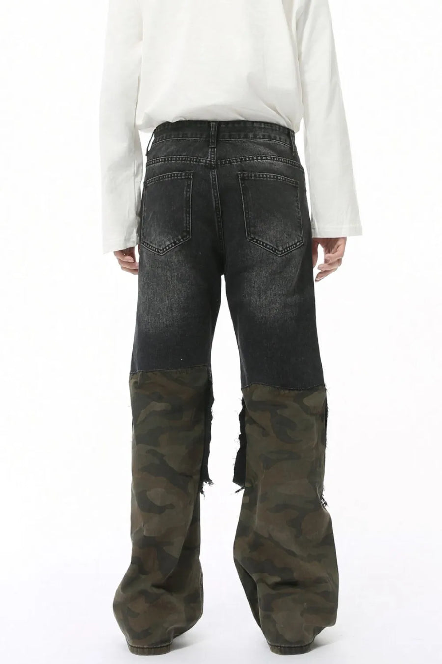 Distressed wide-leg jeans with dark denim and camouflage panels, featuring raw hems.