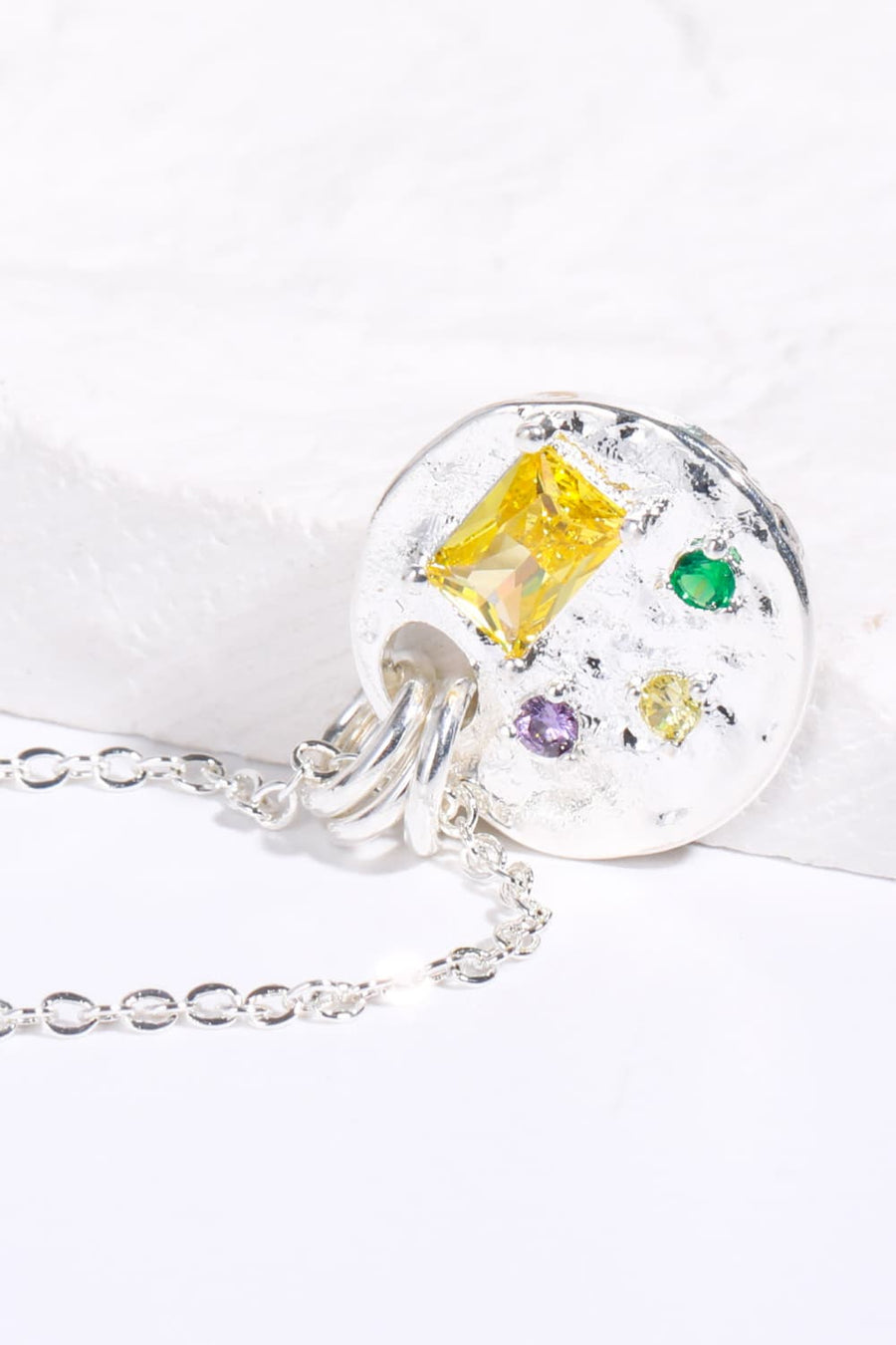 Silver textured disc pendant necklace with gemstone accents