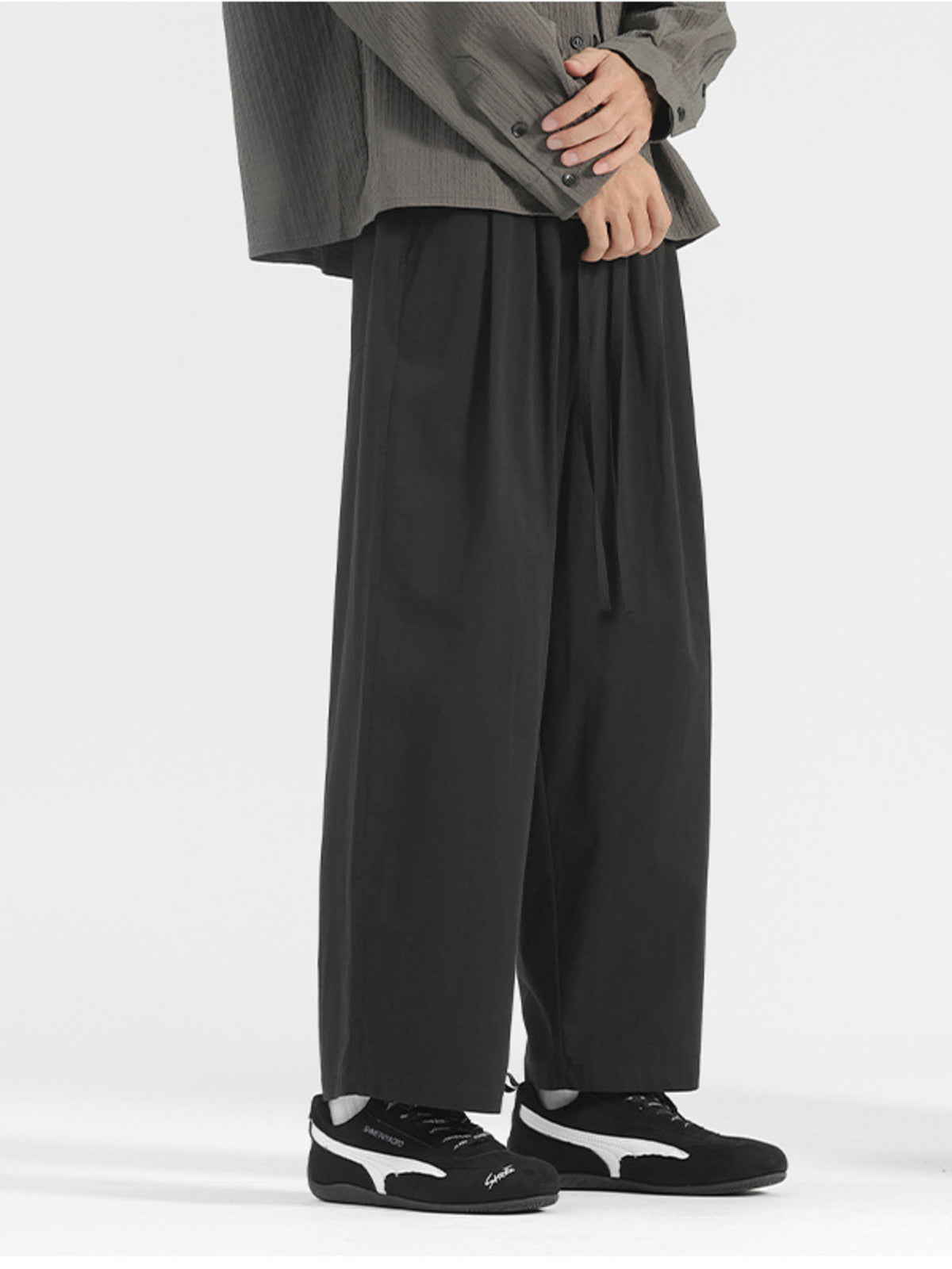 Men's black wide-leg drawstring casual trousers with a relaxed fit.