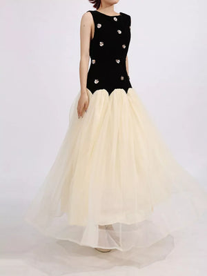 Black velvet sleeveless dress with floral embellishments and a cream tulle skirt.