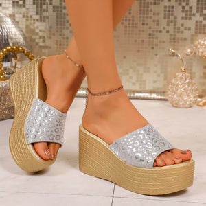 Glamorous leopard print platform sandals in silver and gold with ankle chains.
