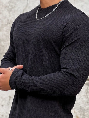 Men's black long sleeve textured tee with round neck.