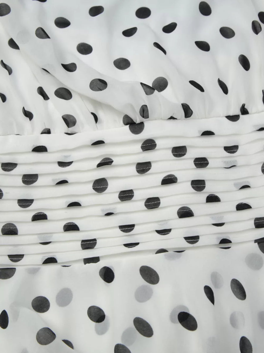 Charming Ruched Halter Neck Mini Dress in white with black polka dots and ruched detail.