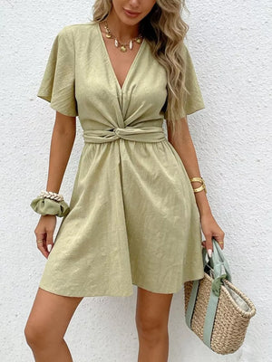 Twist waist mini dress in light green with flutter sleeves and a V-neck.