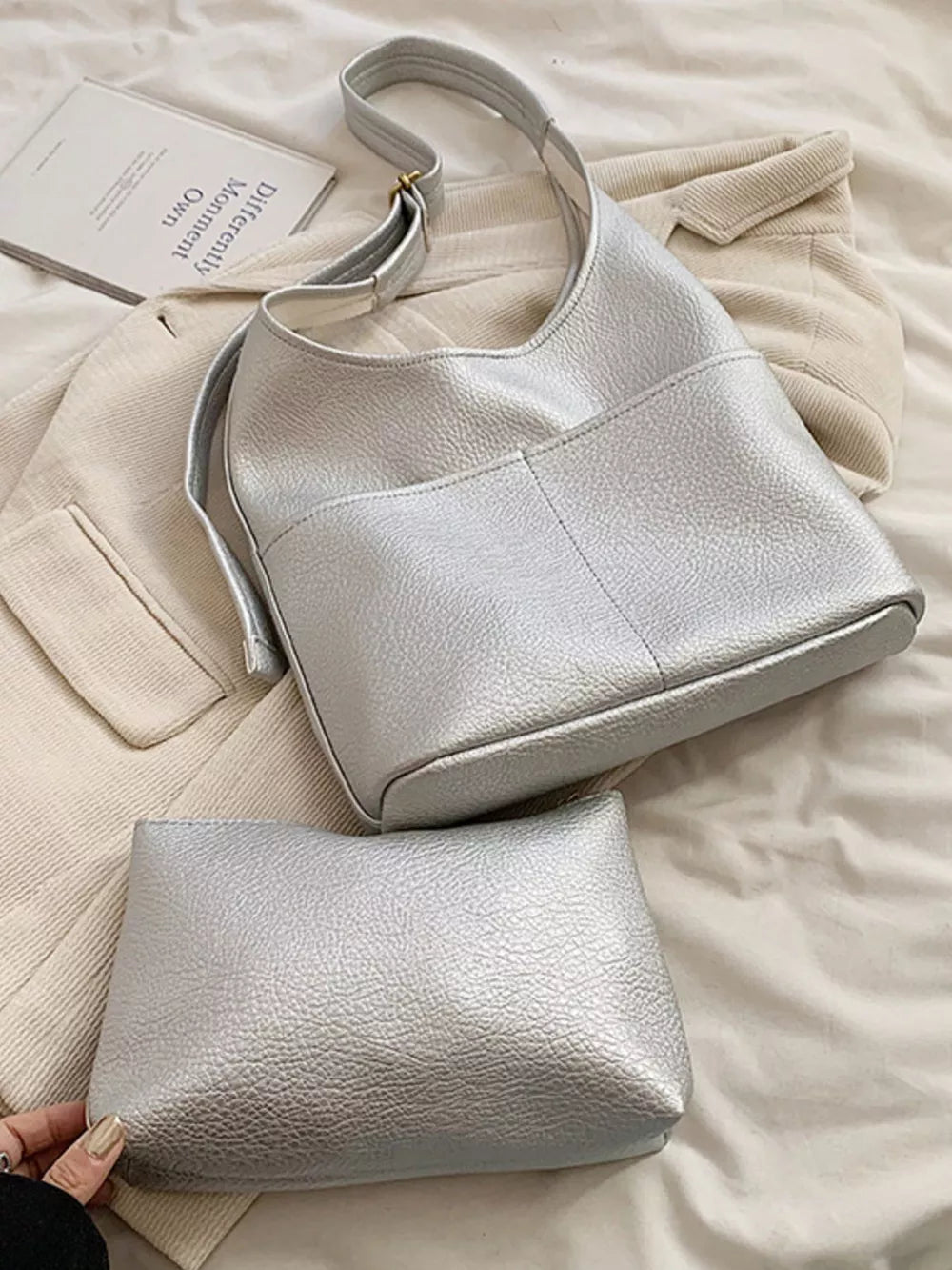 Textured pu leather shoulder bag in silver with adjustable strap and matching pouch.