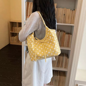 shoulder bag in yellow featuring bowknot detail and relaxed fit