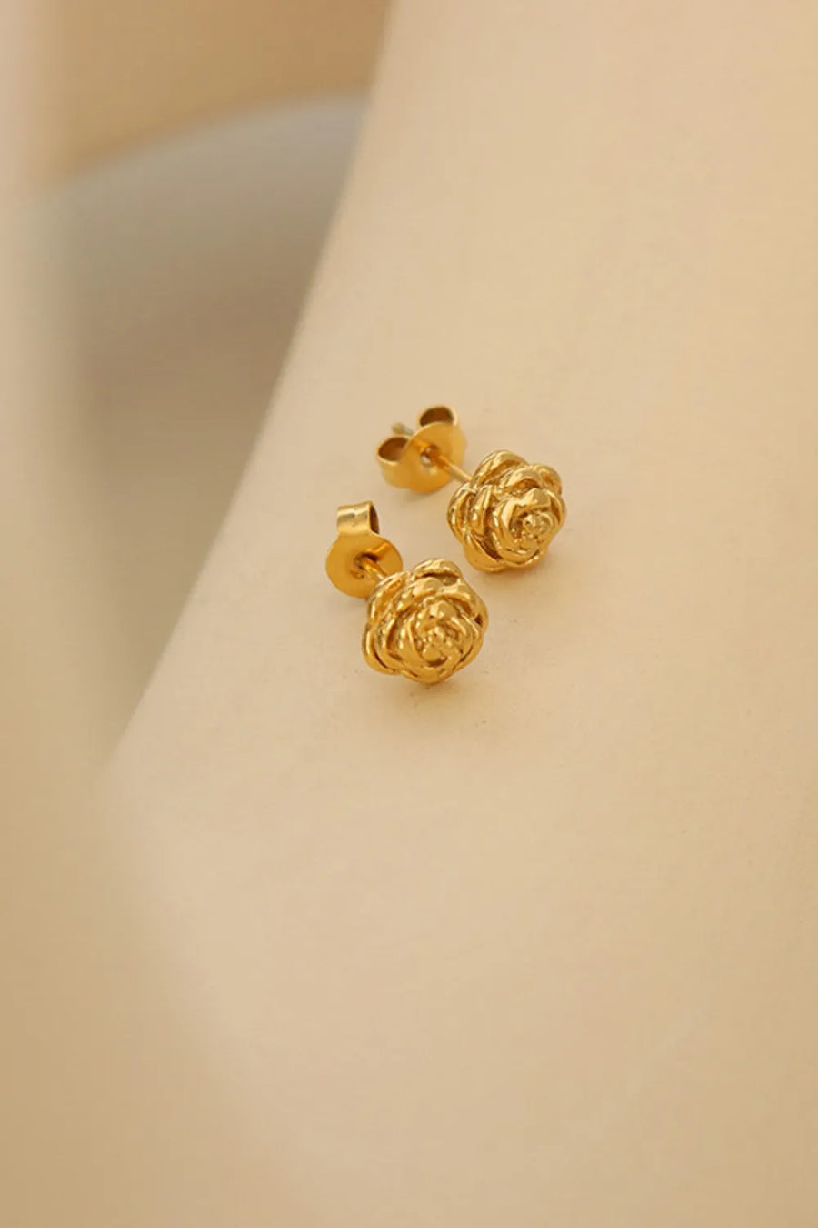 Gold rosebud stud earrings with 18K gold plating.
