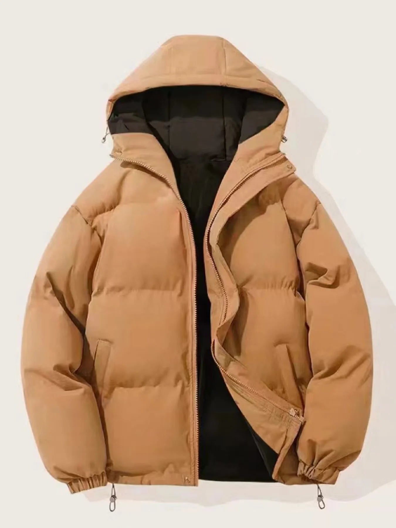 Brown oversized puffer jacket with hood and zip closure, featuring deep pockets.