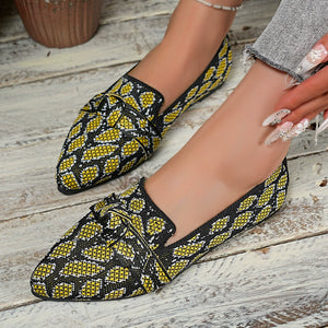 Yellow abstract print slip-on flats with knot detail and pointed toe.