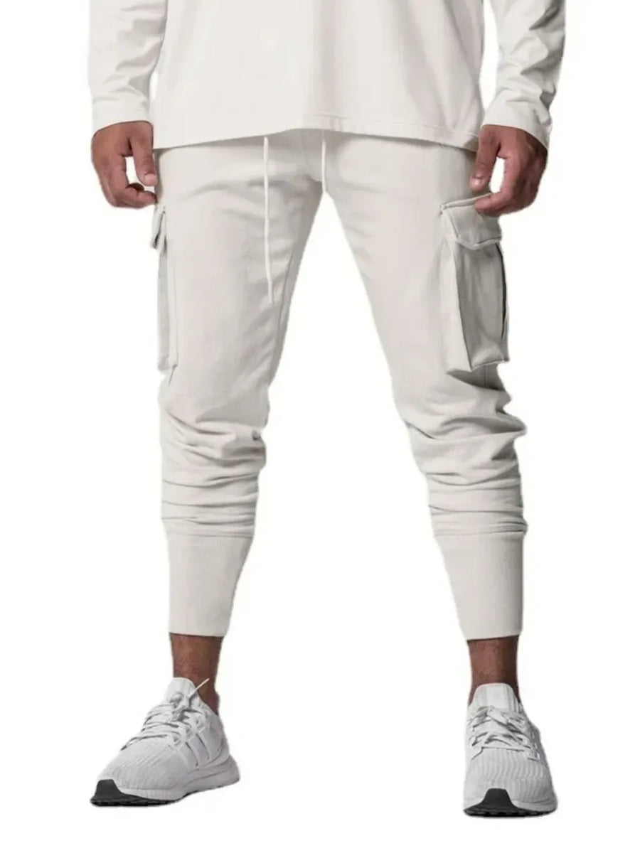 Tech-Knit cargo joggers in white with drawstring waist and zip pocket detail.