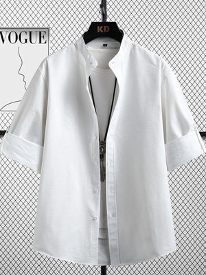 White textured short sleeve shirt with mandarin collar and rolled cuffs.