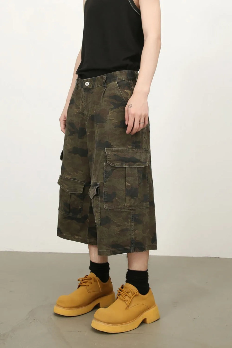 Camo culotte cargo shorts in green camouflage with multiple pockets.