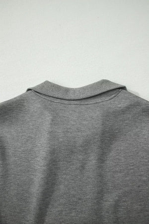 Dark gray half-zip polo sweatshirt detail with ribbed collar
