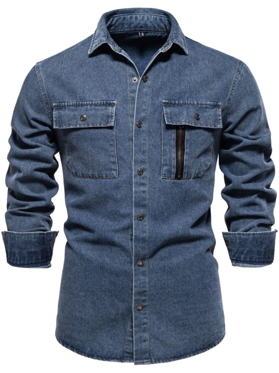 Light blue denim utility shirt with two chest pockets, one with a zip closure.