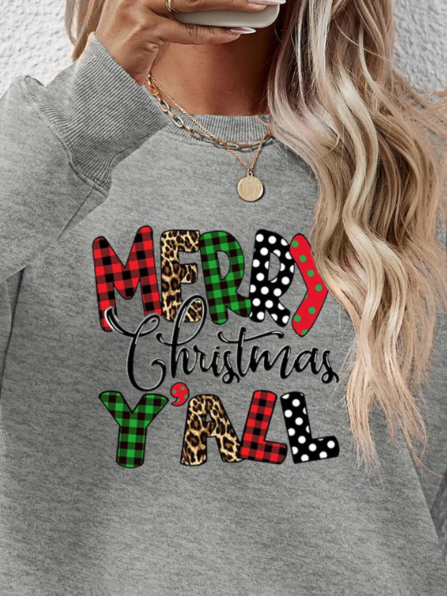 Grey crewneck sweatshirt with festive "Merry Christmas Y'all" graphic in mixed prints: plaid, leopard, polka dot.