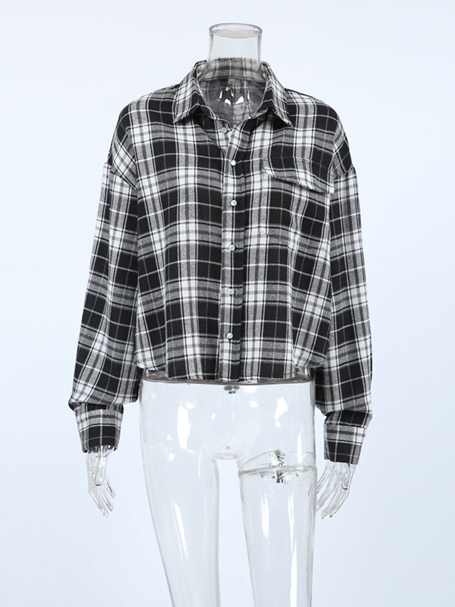 Oversized black and white plaid cotton button-up shirt with collar and chest pocket.