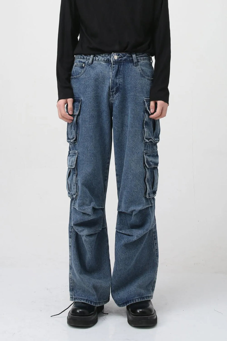 Baggy denim cargo pants in medium wash with multiple utility pockets and a relaxed fit.