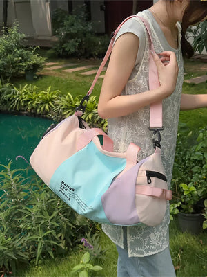 Vibrant pastel nylon duffle bag with color-blocked panels and adjustable strap.