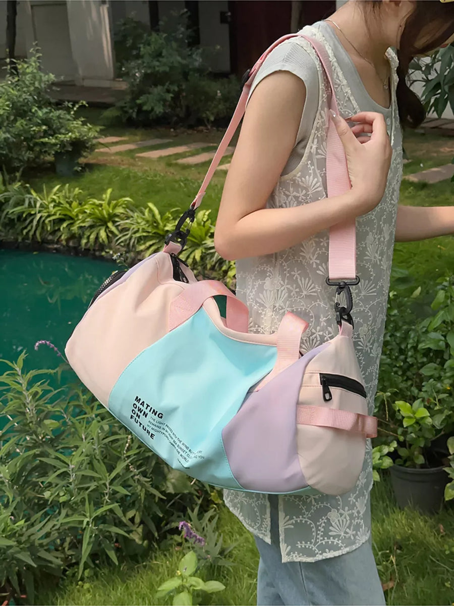 Vibrant pastel nylon duffle bag with color-blocked panels and adjustable strap.