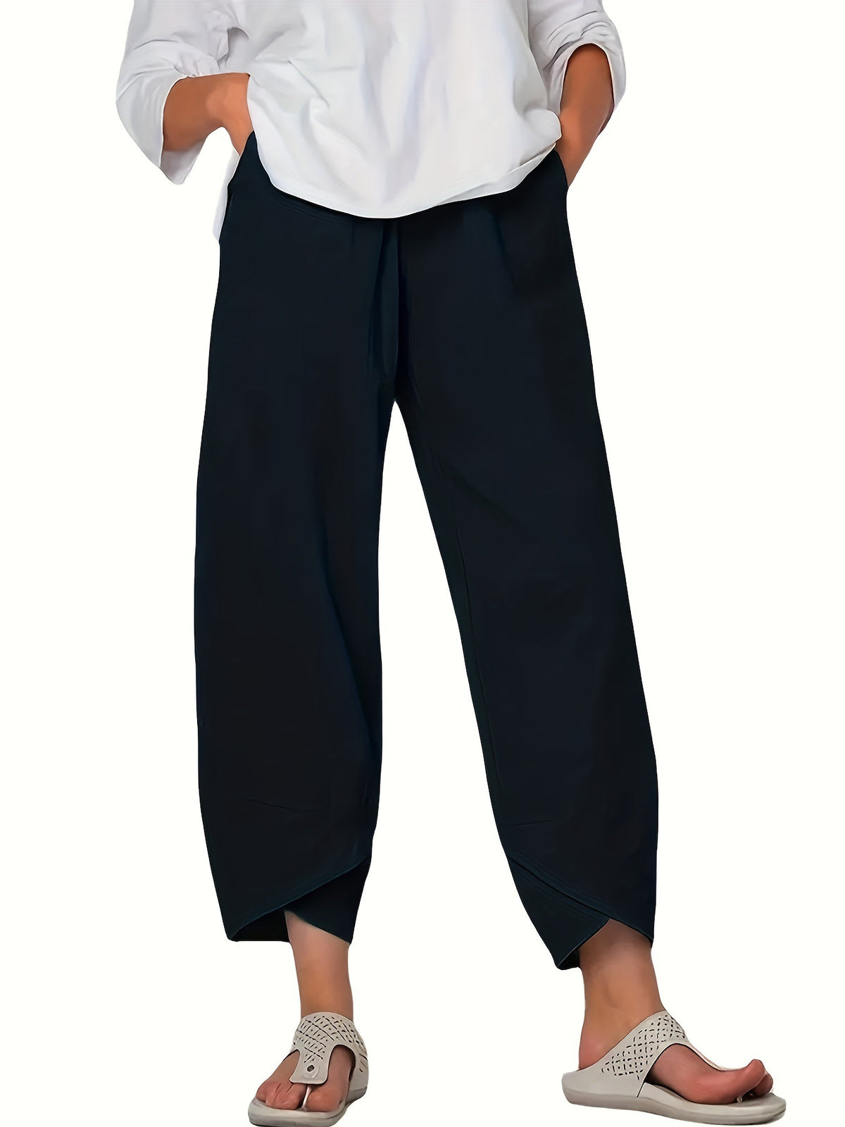 Navy blue relaxed fit wide-leg pants with pockets and asymmetrical hem detail.