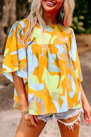 Vibrant abstract print polyester maternity shirt with wide sleeves and a gathered empire waist.