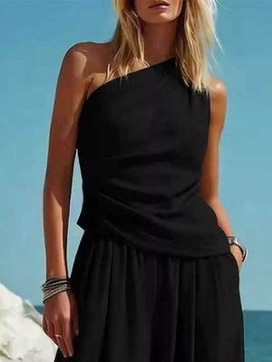 Black one-shoulder top and wide-leg pants set with draped detail.