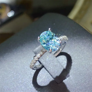 Silver ring with oval aqua moissanite and pavé band