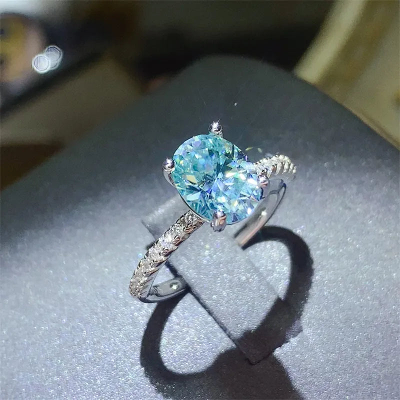 Silver ring with oval aqua moissanite and pavé band