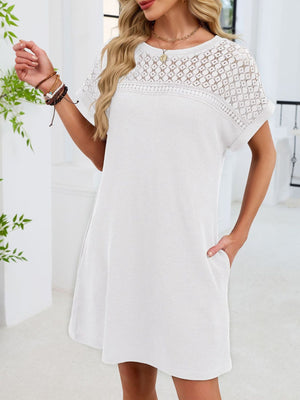 White t-shirt dress with short sleeves and a sheer lace yoke detail.