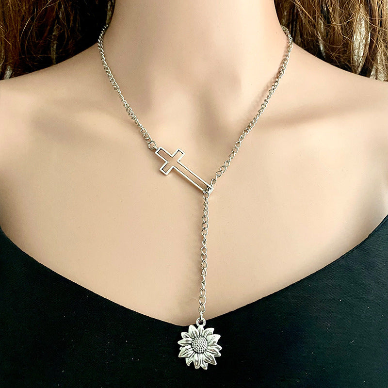 Silver asymmetrical cross lariat necklace with sunflower pendant.