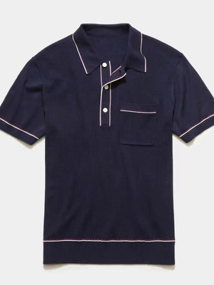 Navy ribbed knit polo shirt with contrast piping and chest pocket.