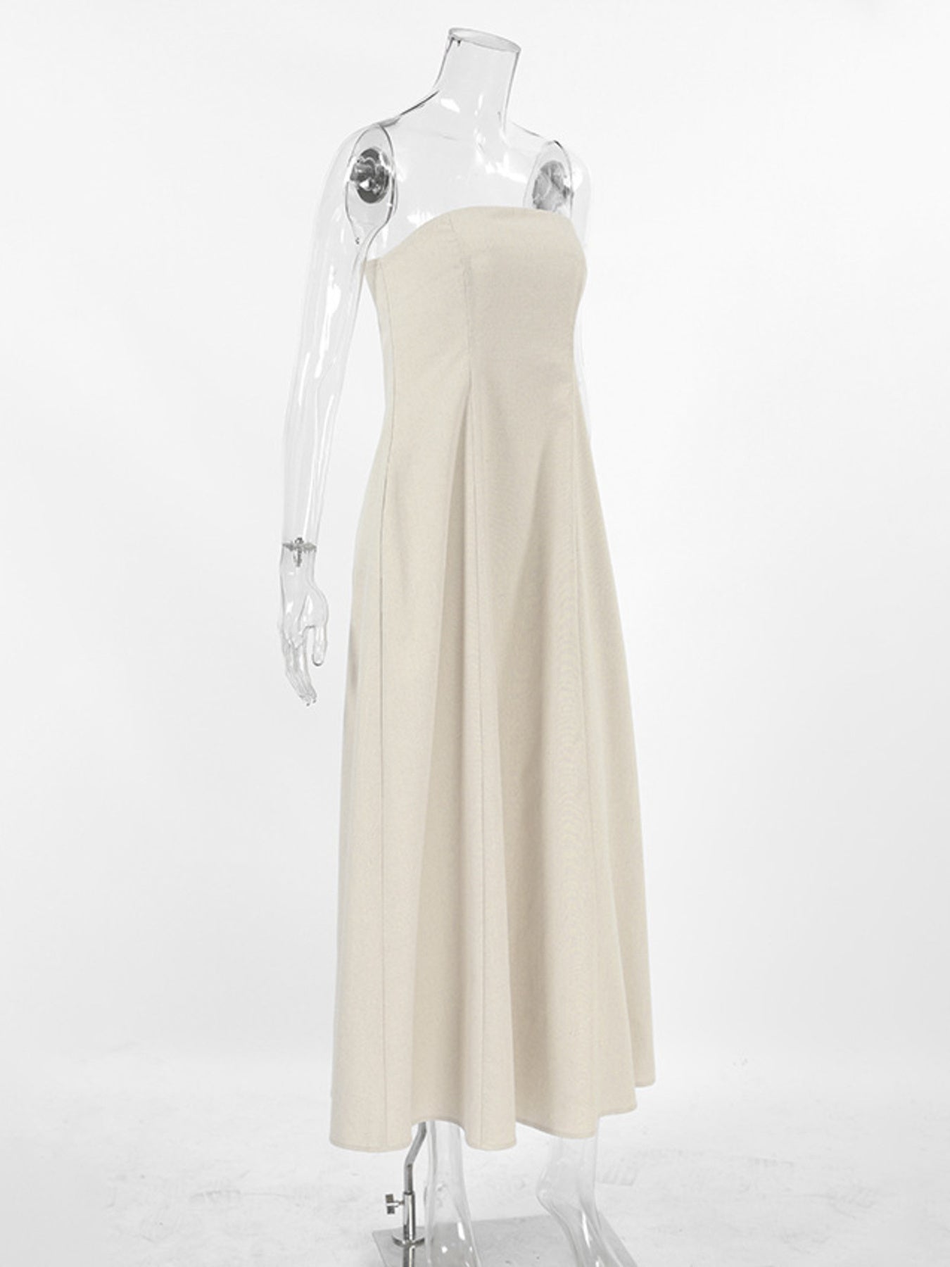 Beige smocked tube dress with a-line cut and zipper detail.