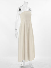 Beige smocked tube dress with a-line cut and zipper detail.