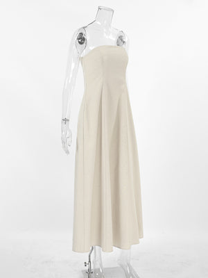 Beige smocked tube dress with a-line cut and zipper detail.