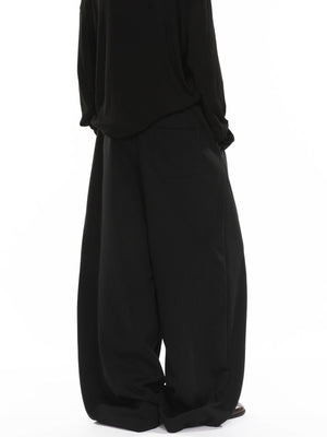 Men's black wide-leg sweatpants with drawstring and back pocket detail.