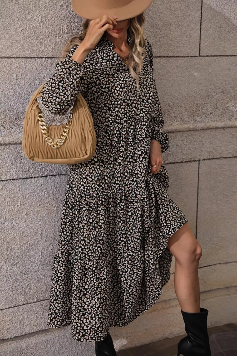 Chic black animal print midi dress with balloon sleeves and tiered skirt.
